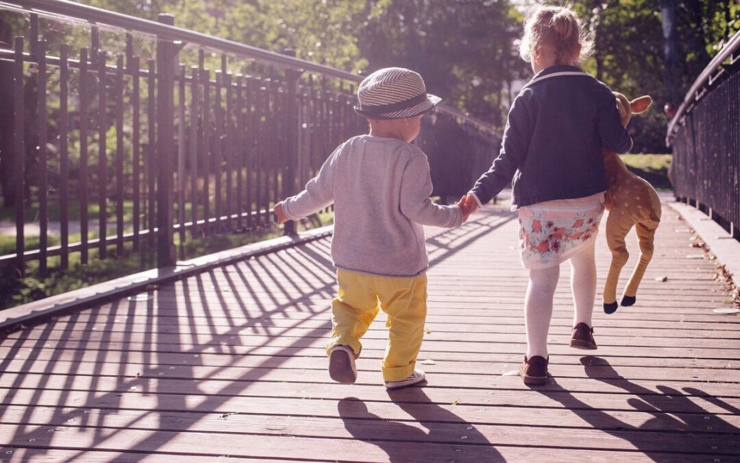 kids holding hands while strolling