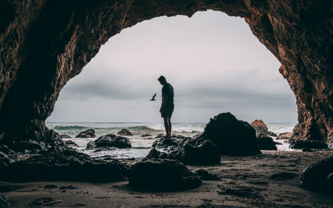 man in a beach cave