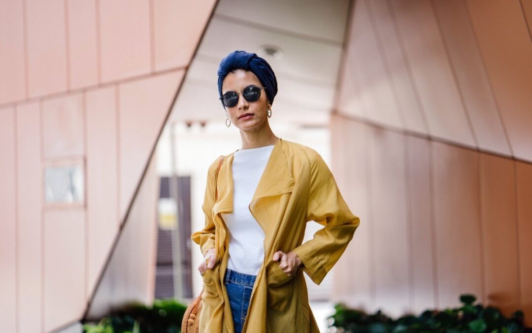 woman wearing a yellow coat and shades